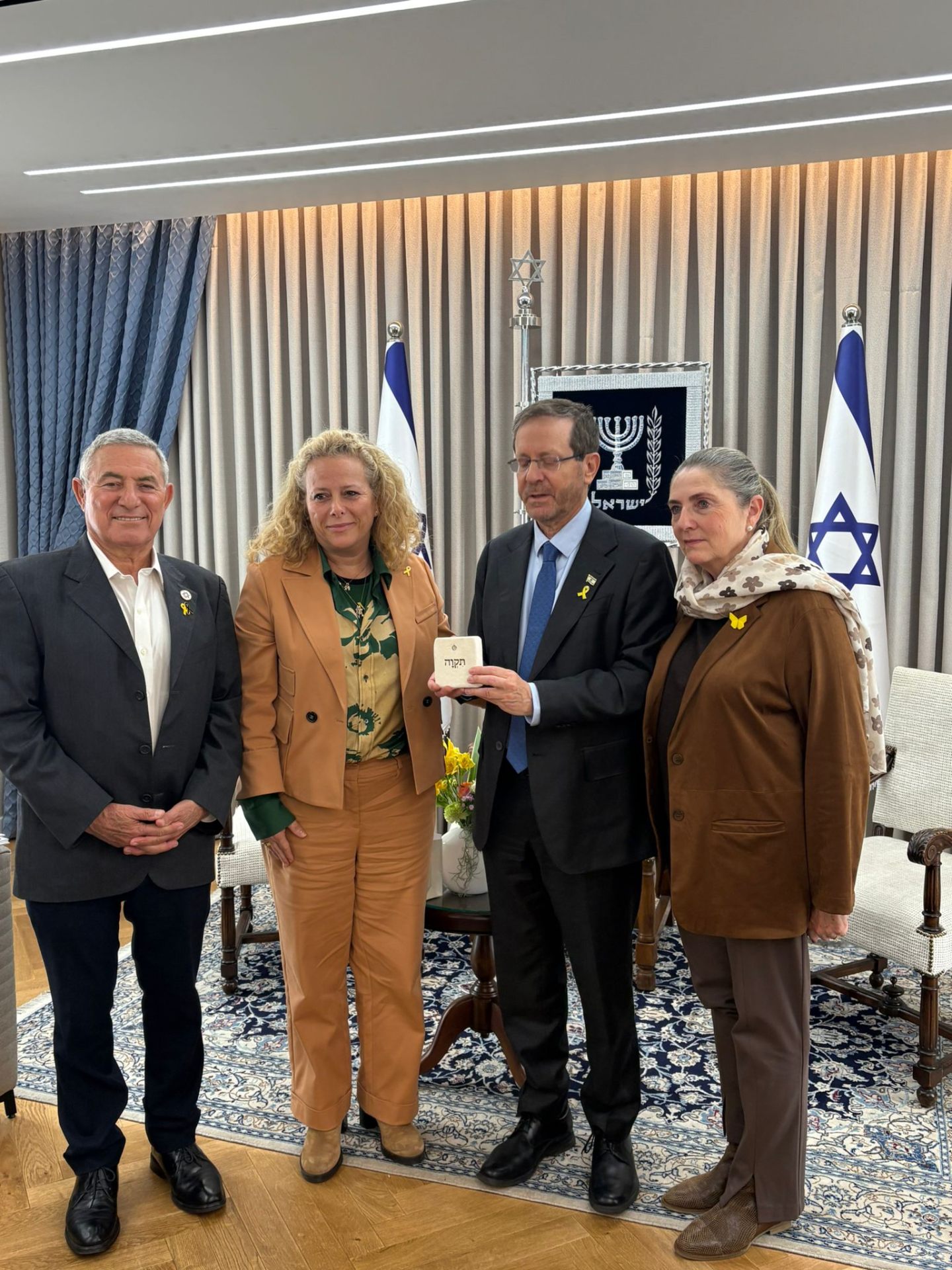 Jewish Agency representatives present President Isaac Herzog with an AHAVA Stone bearing the word Tikva
